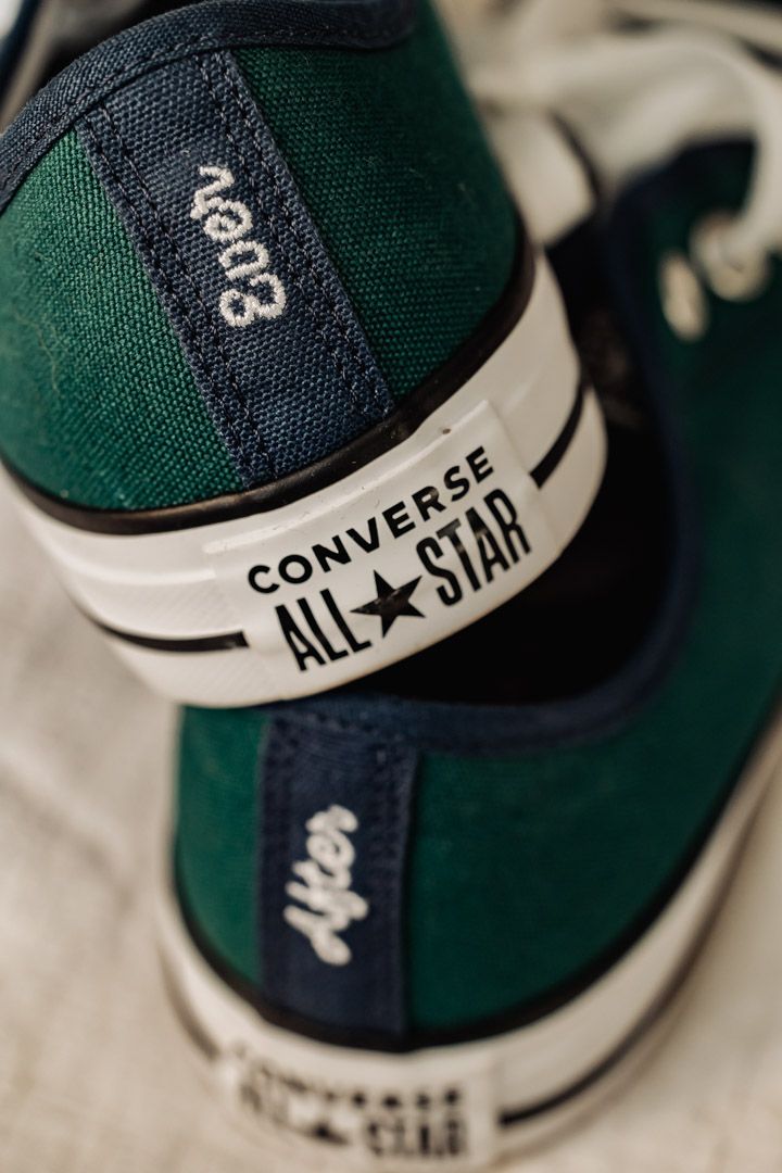Close up detail of a green and navy Converse All Star sneaker.