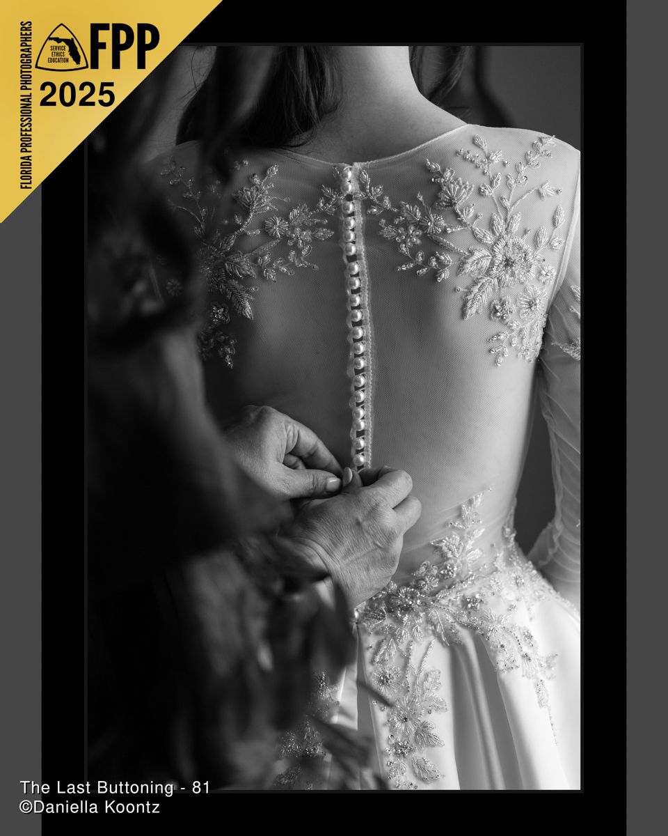 FPP 2025 black and white award-winning photo of hands buttoning the back of a lace wedding gown.