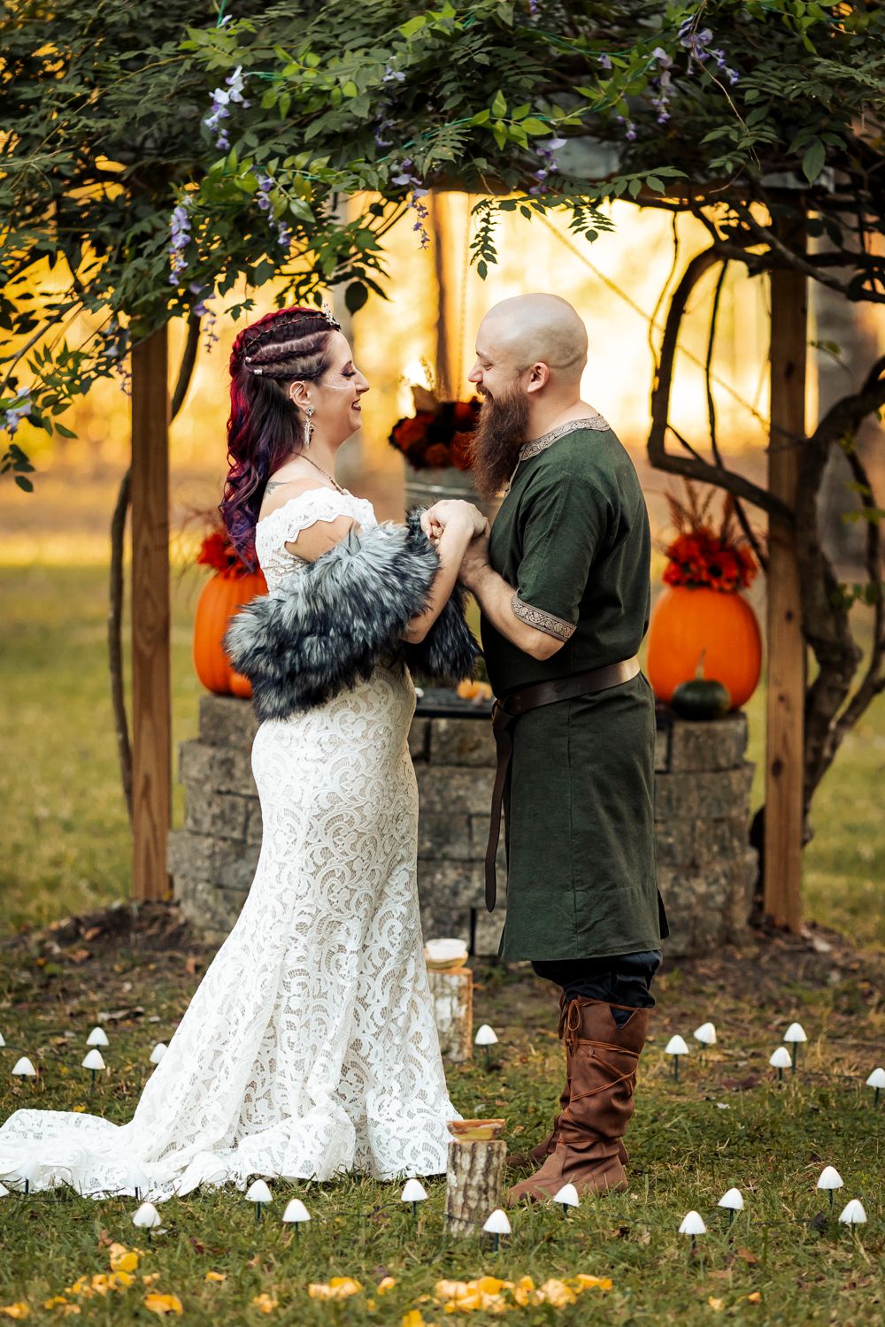 Romantic medieval wedding scene with couple in period dress under autumn archway.