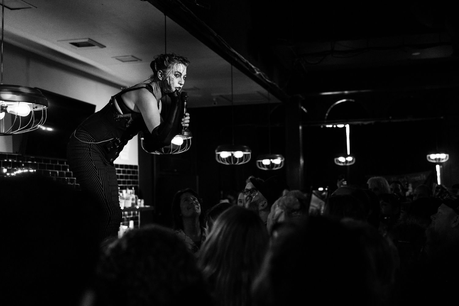 Amanda Palmer, Dresden Dolls, The Social Orlando FL, June 18 2023, black and white, performing on bar above crowd