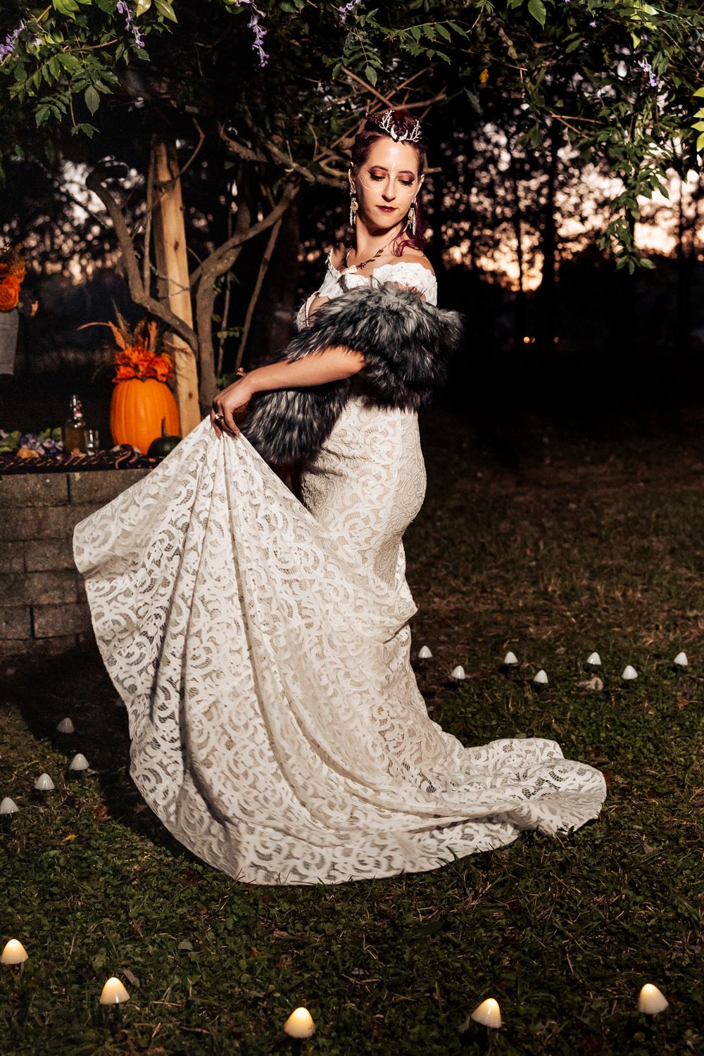A dramatic wedding dress photo shows intricate lace details and fur accents against a twilight garden setting.