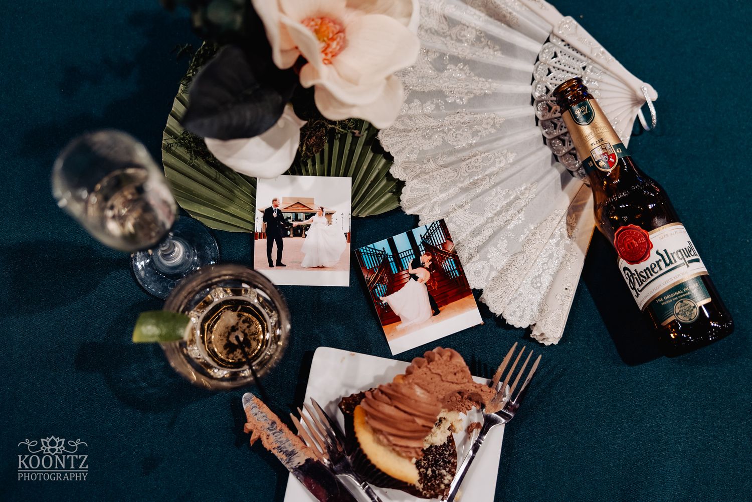 Artistic overhead view of wedding memorabilia and photographs arranged in a fan pattern.
