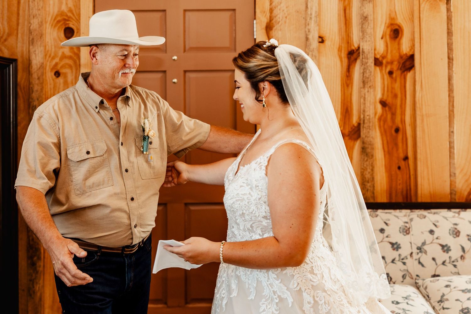 An emotional exchange between bride and companion during a wedding first look.