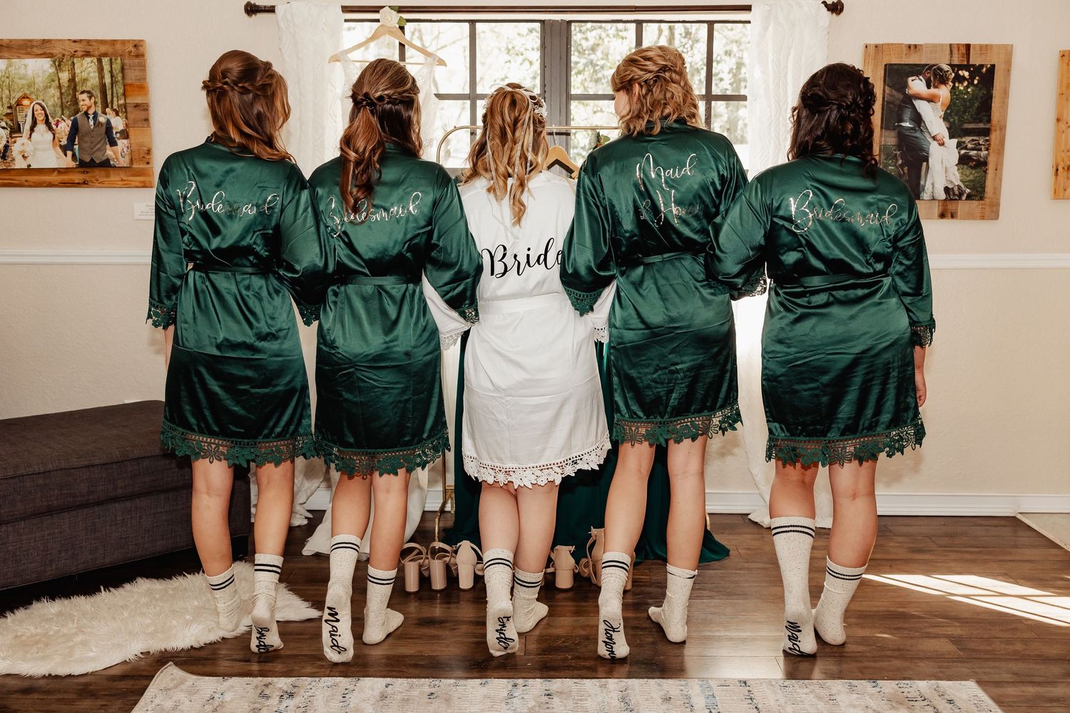 Wedding party wearing matching emerald green robes standing in line showing off their shoes.