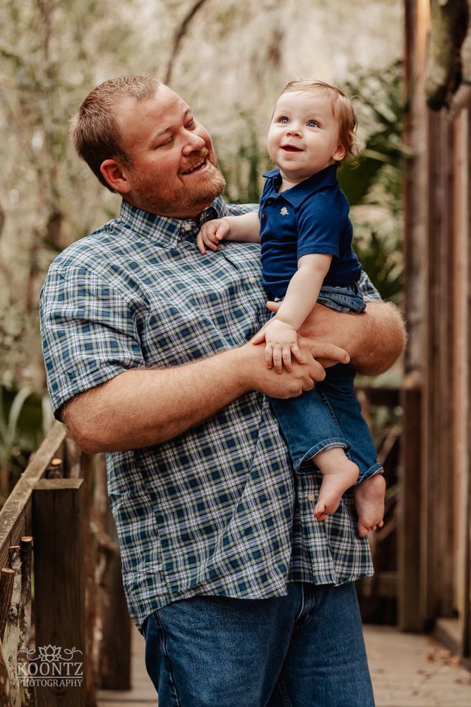 A heartwarming outdoor portrait showing a happy moment between two people in casual attire.