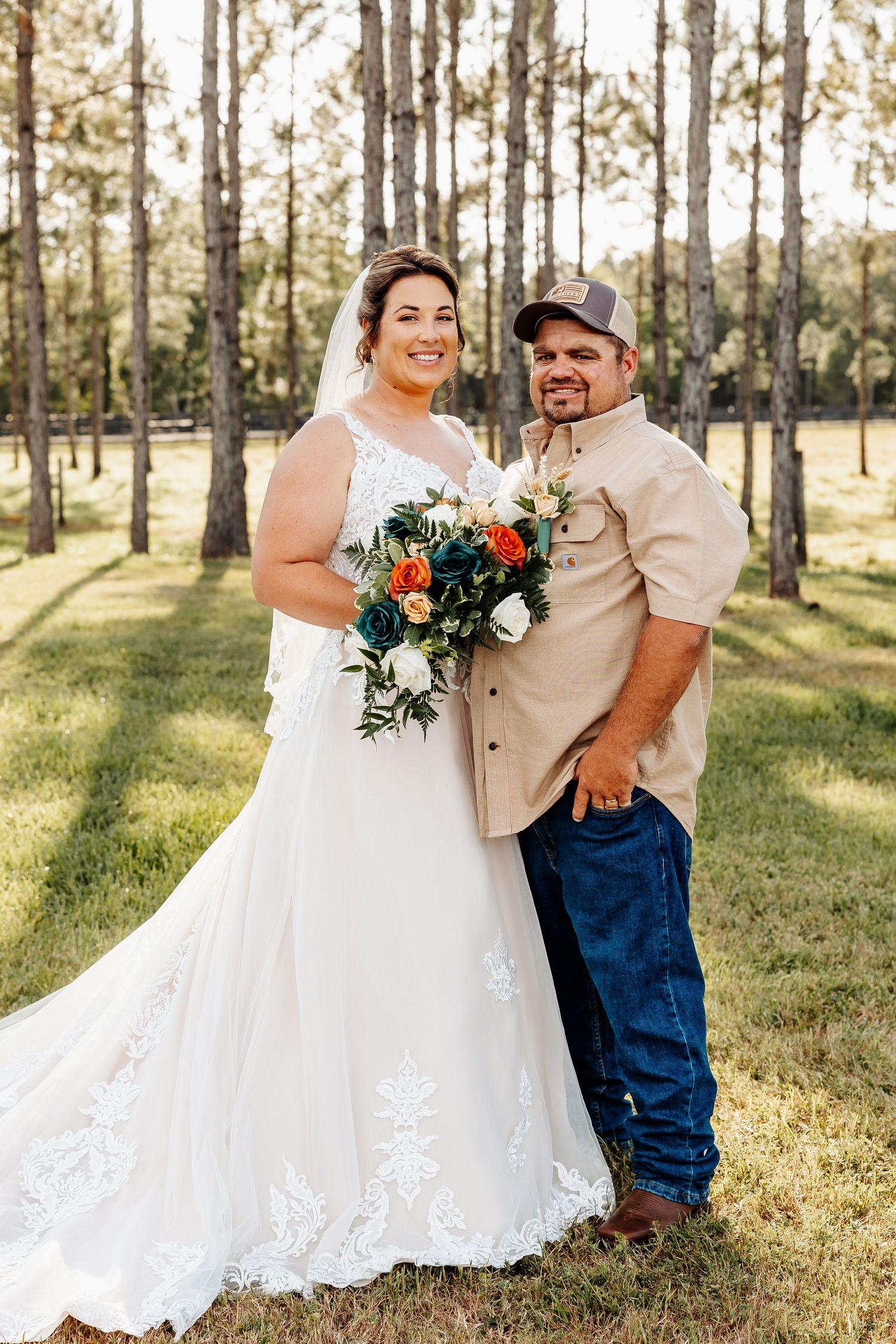 Wedding portrait in a serene pine forest setting.