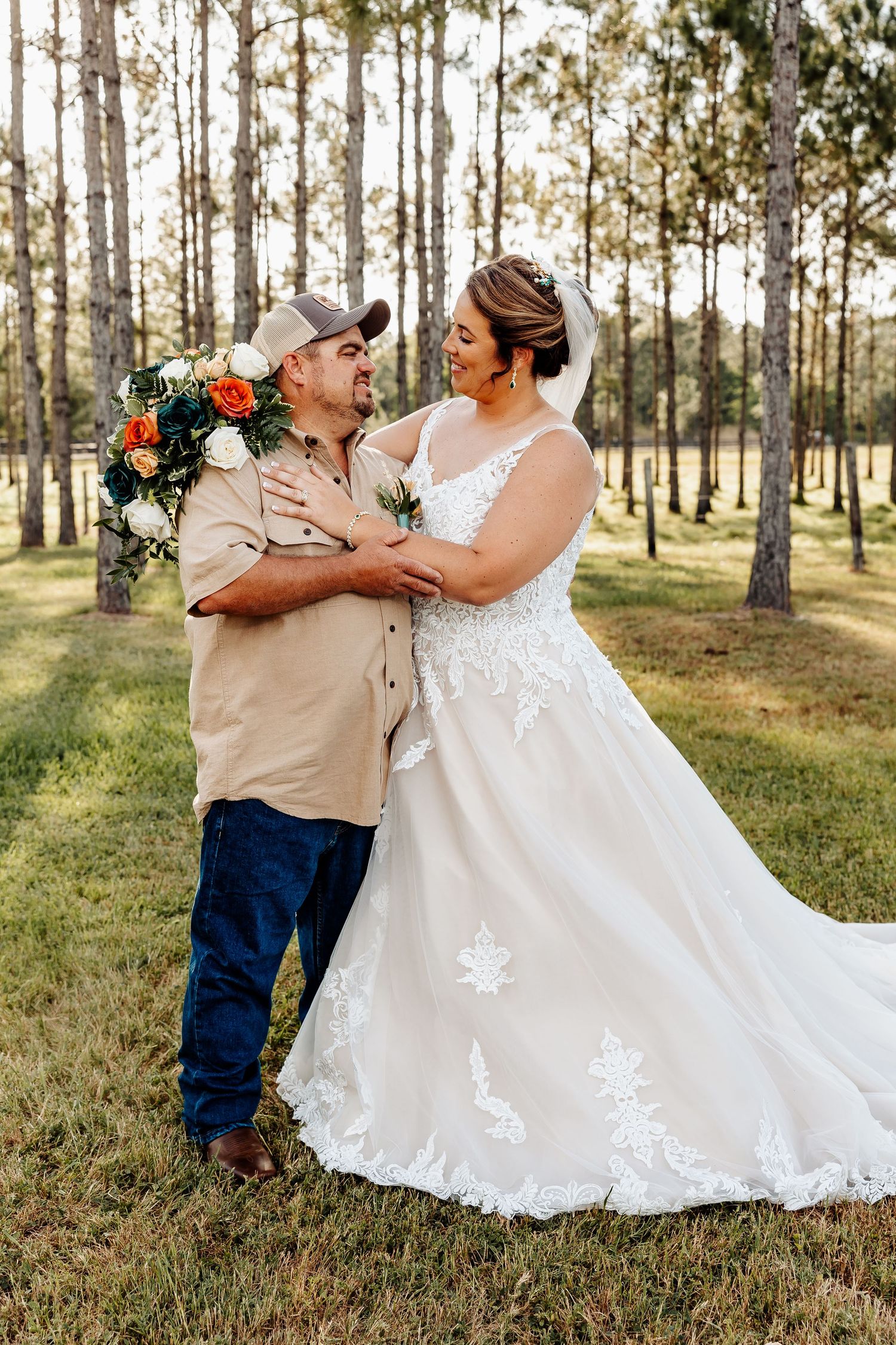 Romantic wedding portrait amongst tall pine trees.