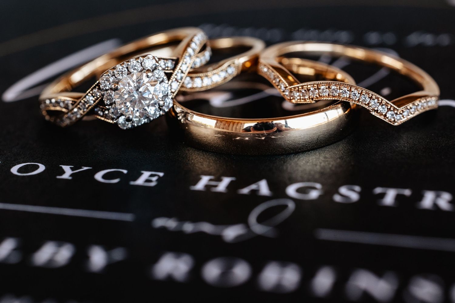 Close-up of elegant rose gold wedding rings with diamonds on a Royce Hagstrom jewelry box.