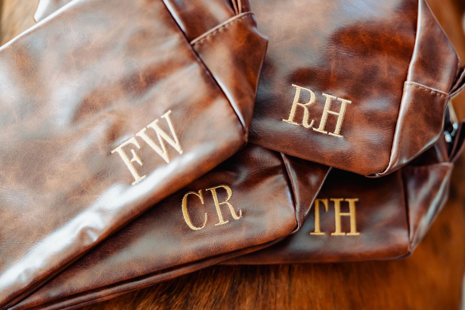 Brown leather accessories with monogrammed initials FW, RH, CB, and TH.