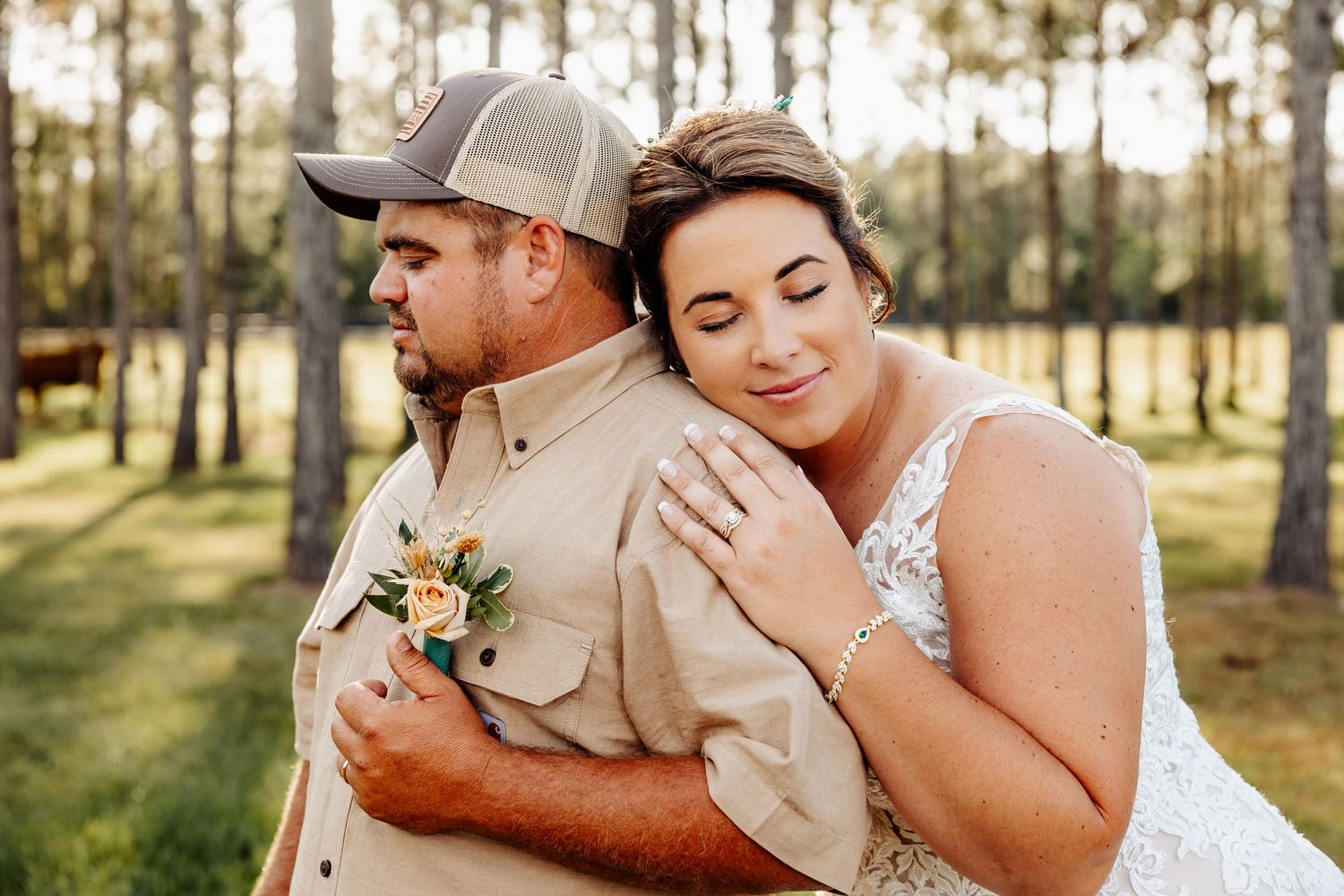 A romantic wedding portrait in a sunlit pine forest setting with a rustic country theme.