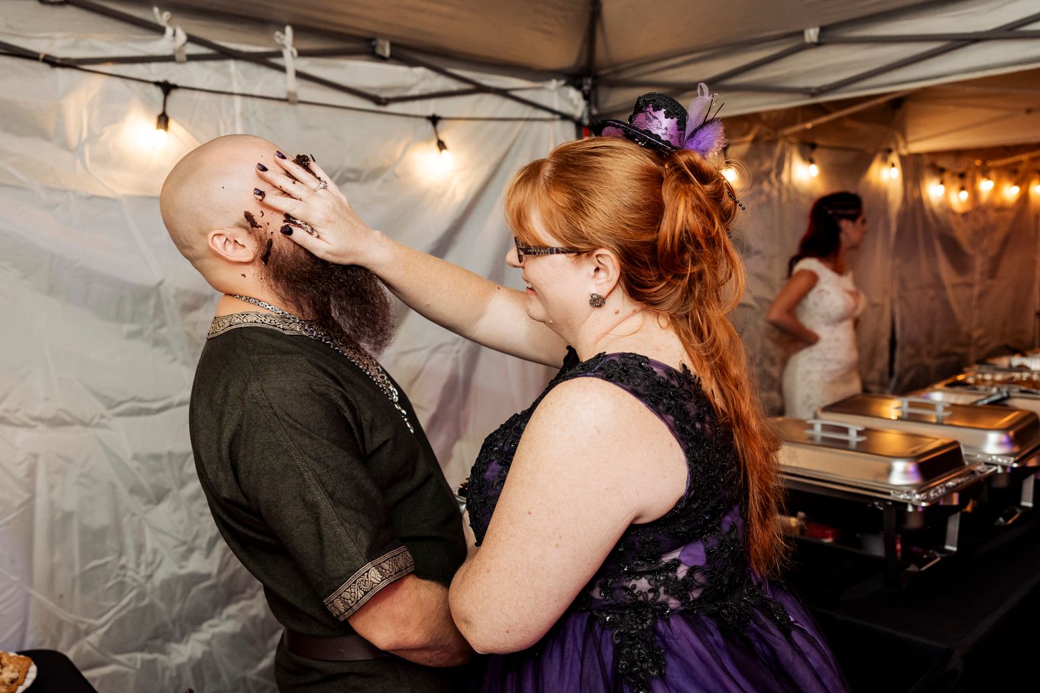 Fun interaction between guests enjoying desserts at wedding reception.