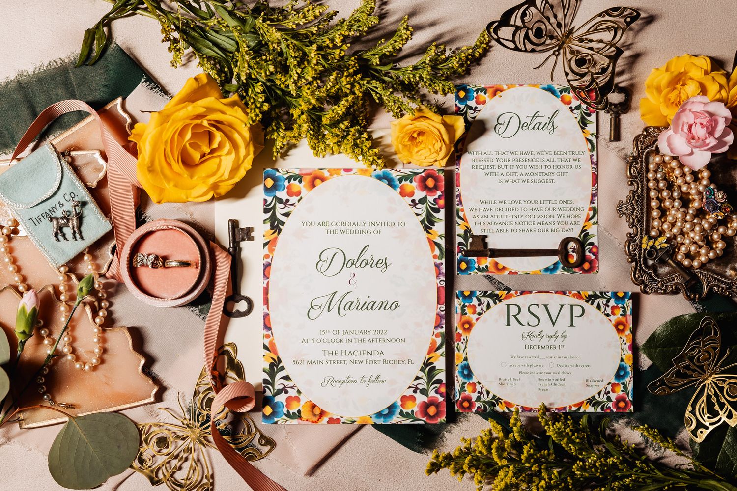 Vibrant floral wedding invitation suite for Dolores and Mariano surrounded by yellow roses.