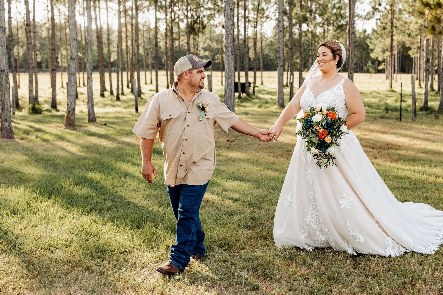 A joyful wedding couple walking hand in hand through a serene pine forest.