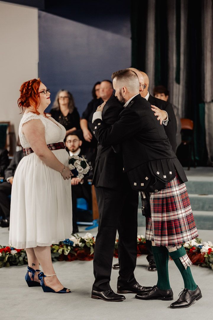 A wedding ceremony featuring traditional Scottish attire including kilts and formal wear.