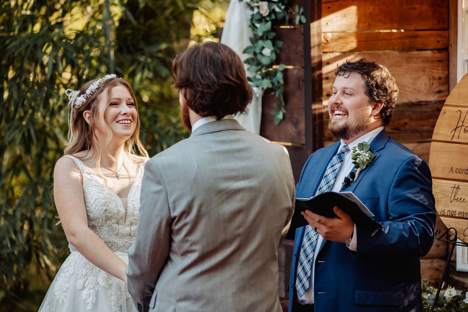 An intimate woodland wedding ceremony with natural light filtering through trees.