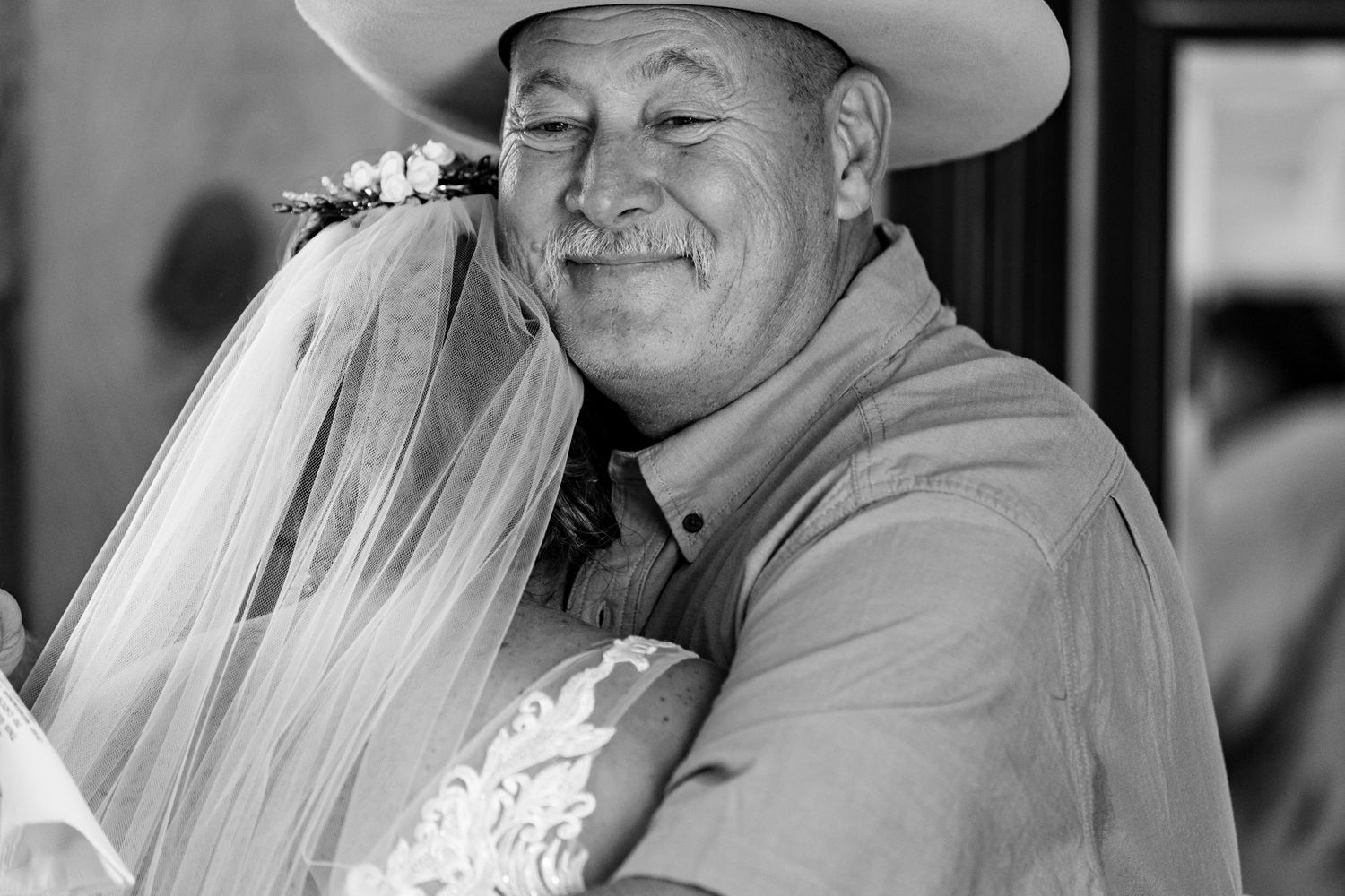 A black and white candid wedding moment showing joy and emotion.
