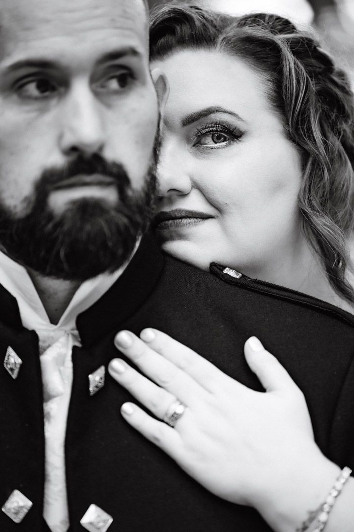 Intimate black and white portrait of couple in traditional Scottish wedding attire.