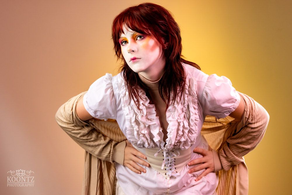 A stylized fashion photo featuring vintage-inspired clothing against gradient background.