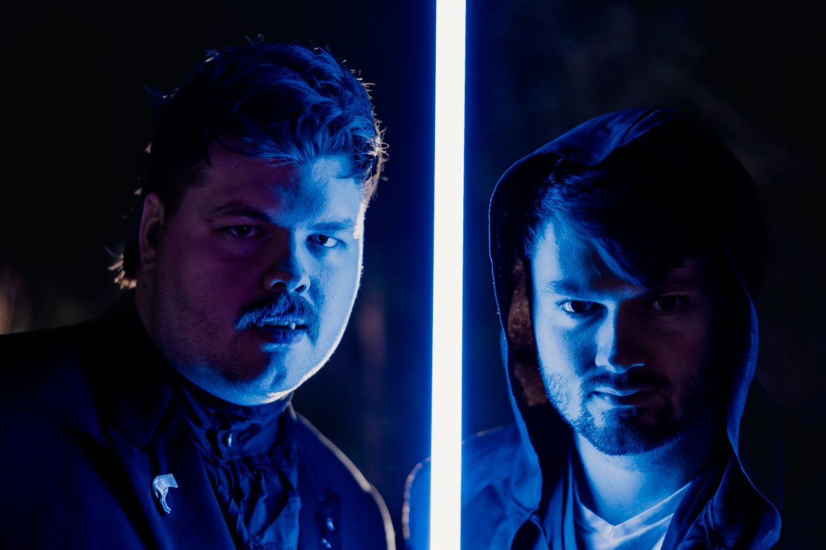 A series of dramatic portraits lit with blue neon lighting creates a moody cinematic atmosphere.