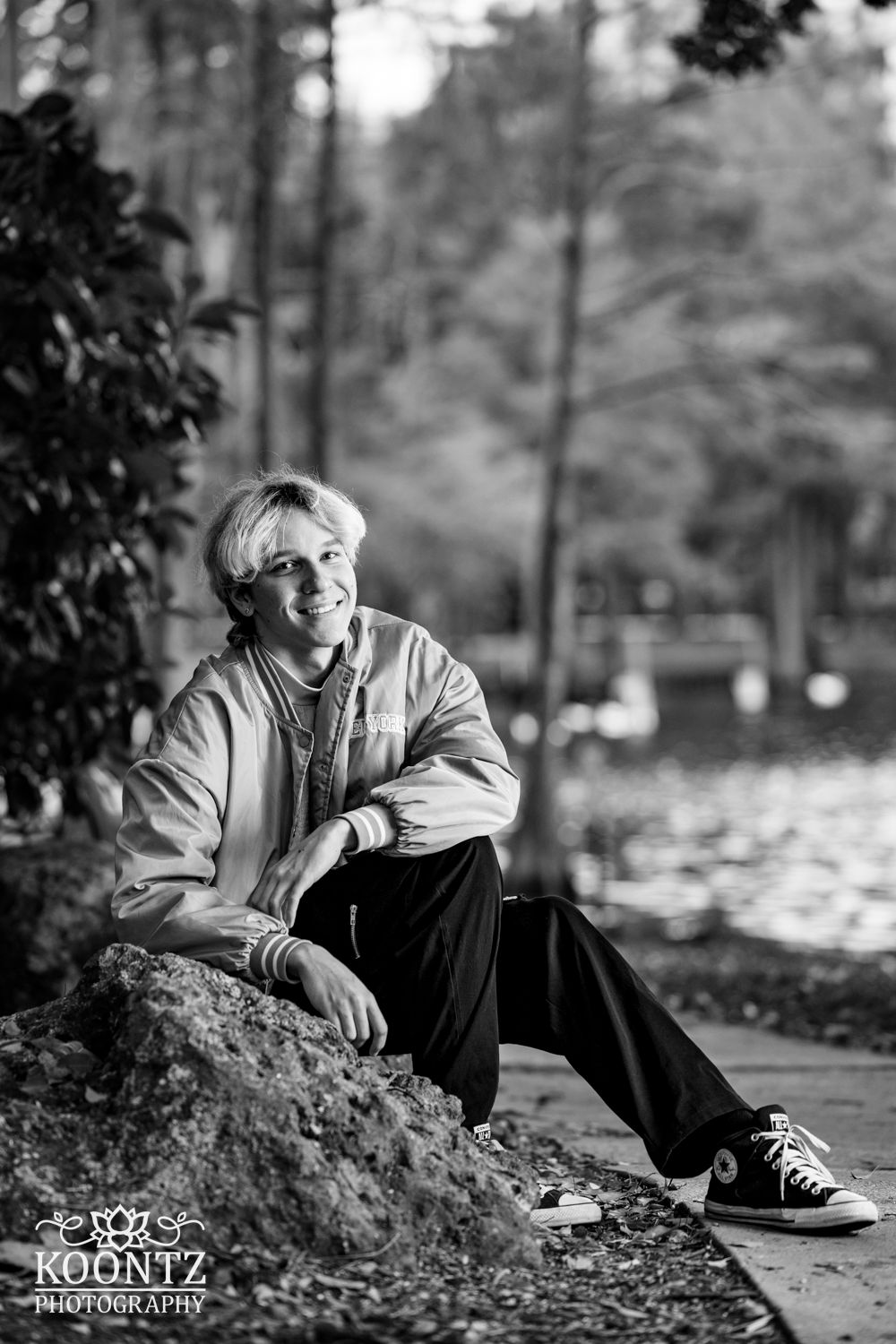 Black and white portrait composition by a lake with natural lighting.