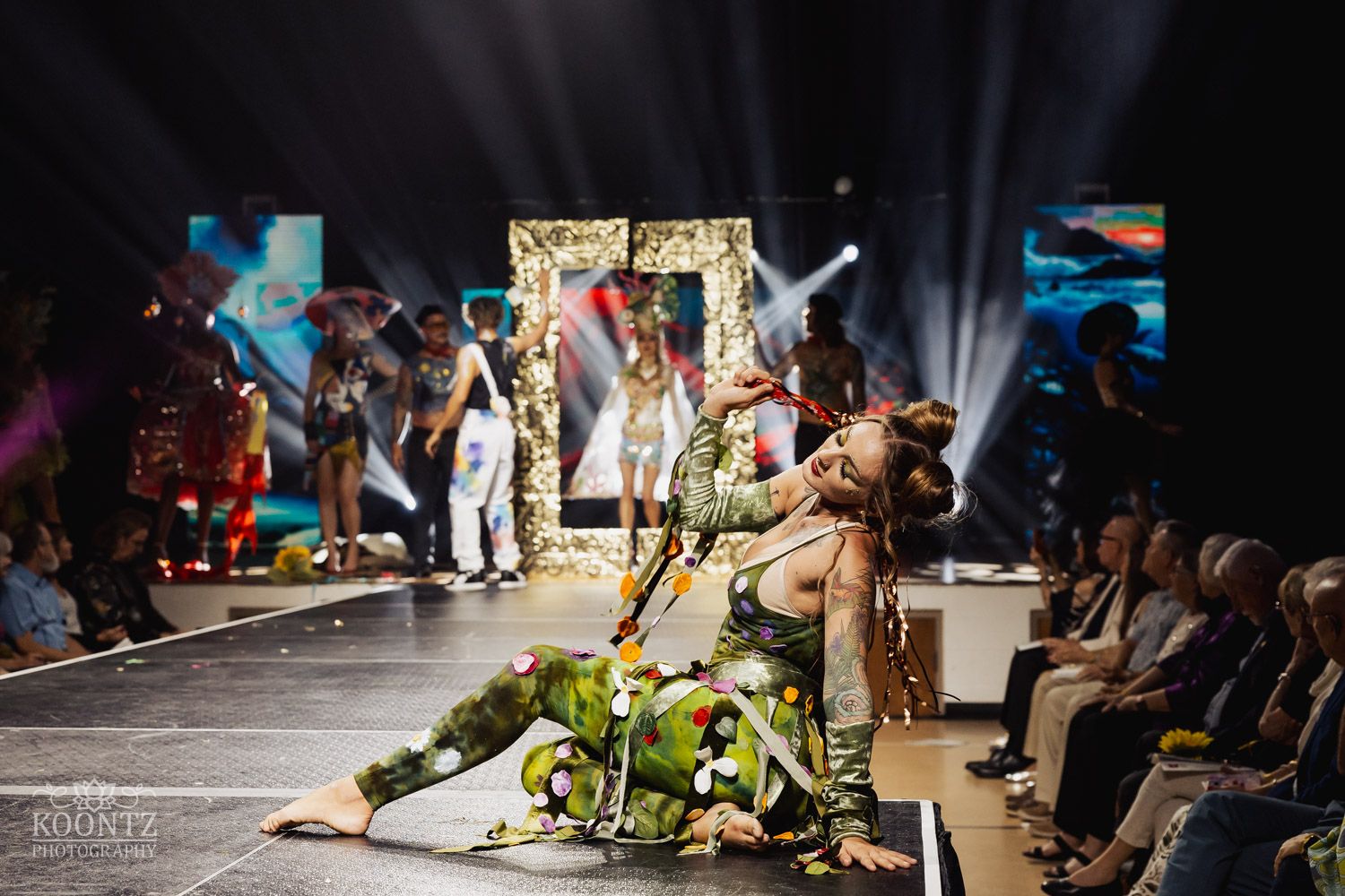 Dancers perform dynamic breakdancing moves on stage during a hip-hop dance competition event.