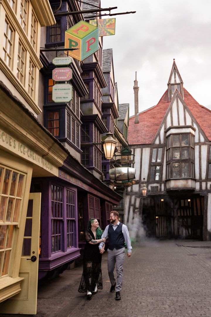 Couple strolling through the magical streets of Diagon Alley at Universal Studios theme park.