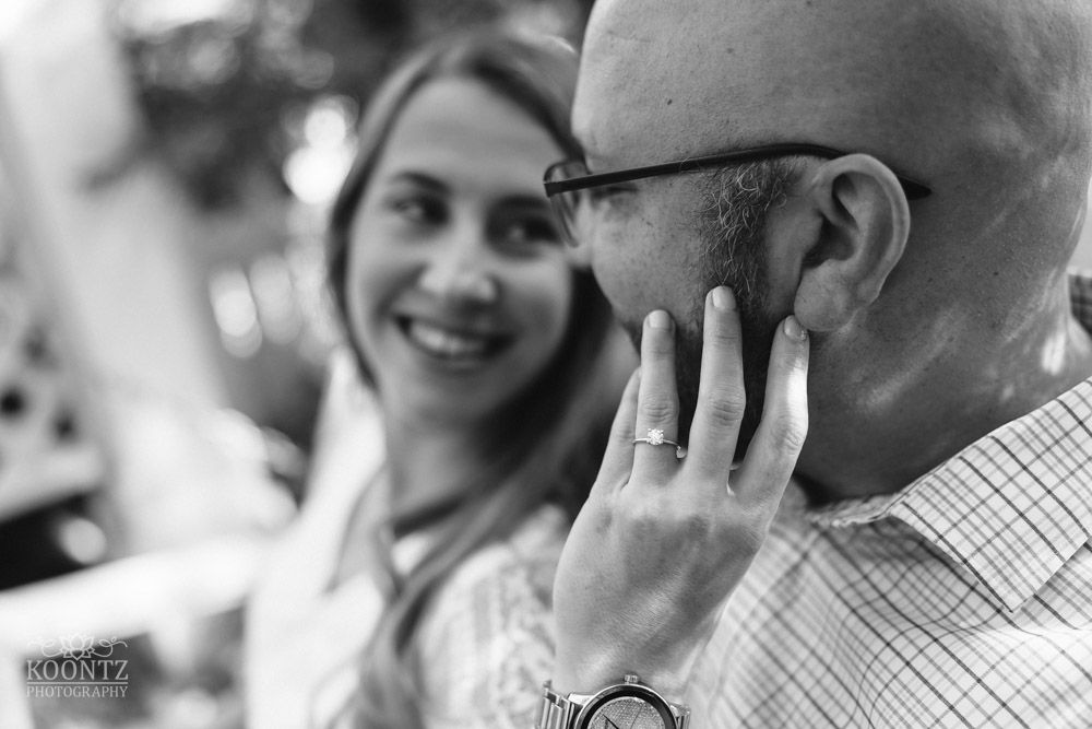 Black and white portrait of a couple sharing an intimate moment in a natural setting.