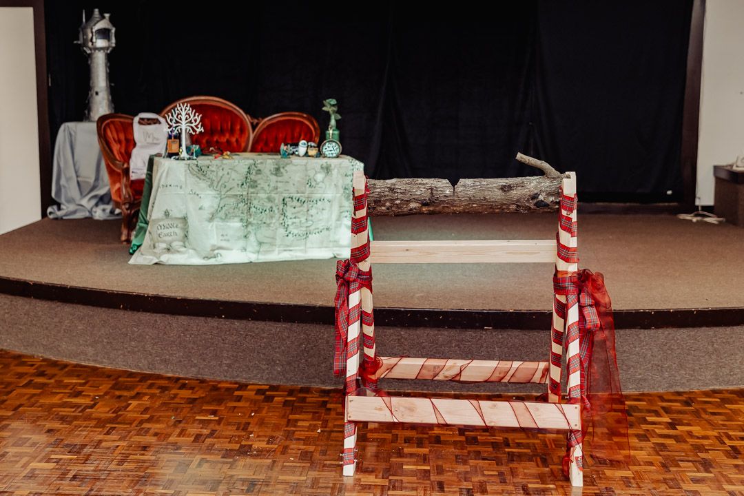 Festive candy cane themed log display with mint green decor on stage setting.