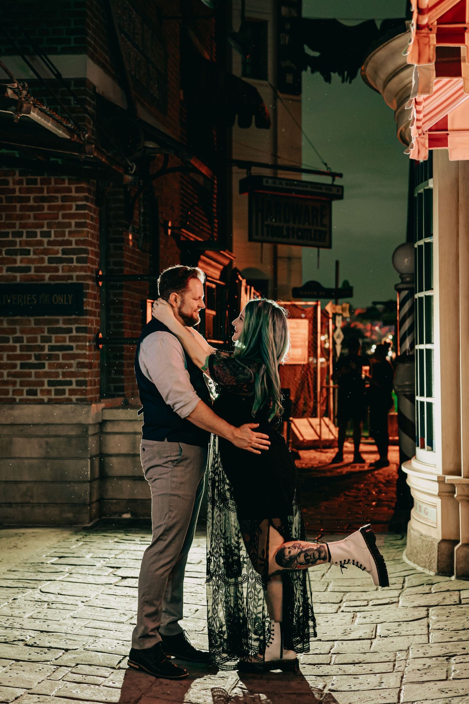 A magical nighttime embrace on cobblestone streets with vintage storefronts.