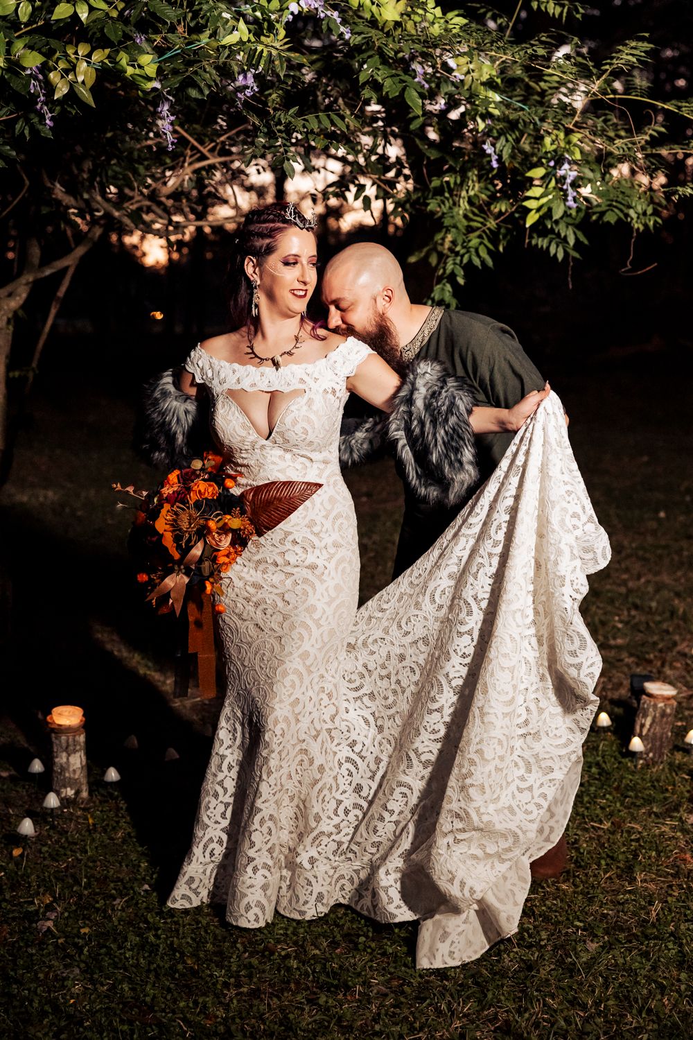 A romantic outdoor wedding photo with lanterns features a lace gown and dramatic poses under tree branches.