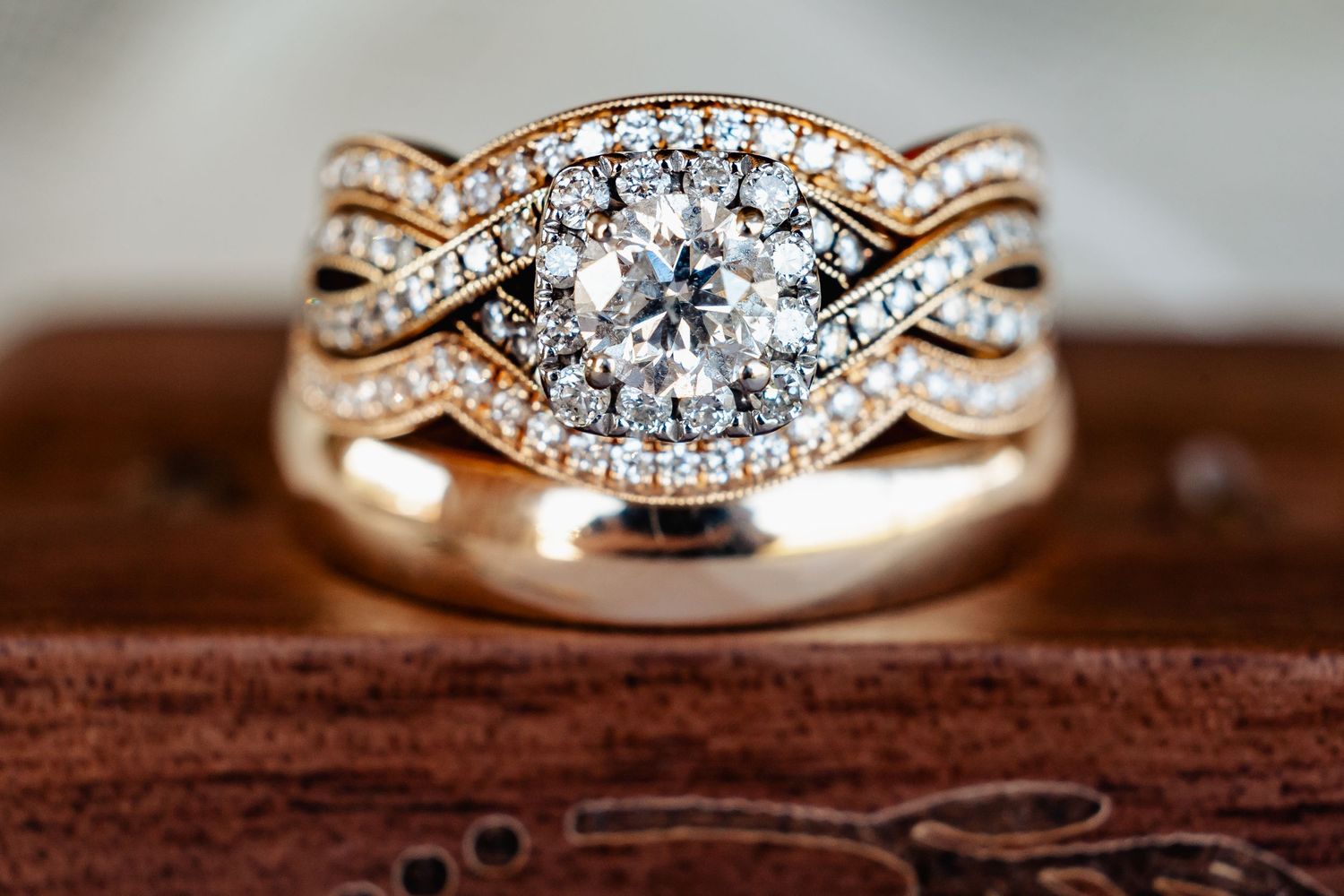 Rose gold diamond engagement ring with intricate twisted band design.