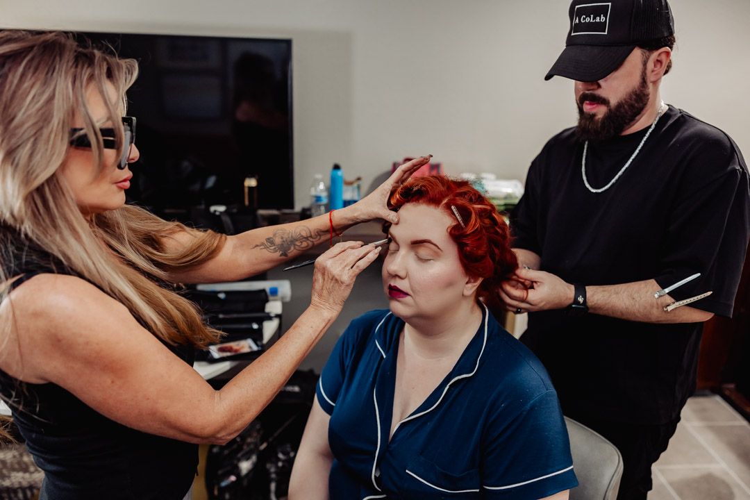 Wedding preparation scene showing styling and makeup session.