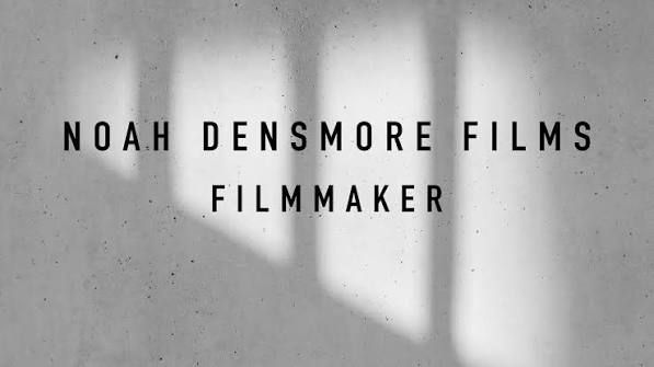 Noah Densmore Films filmmaker logo displayed on a minimalist gray concrete wall with soft natural light and shadows.