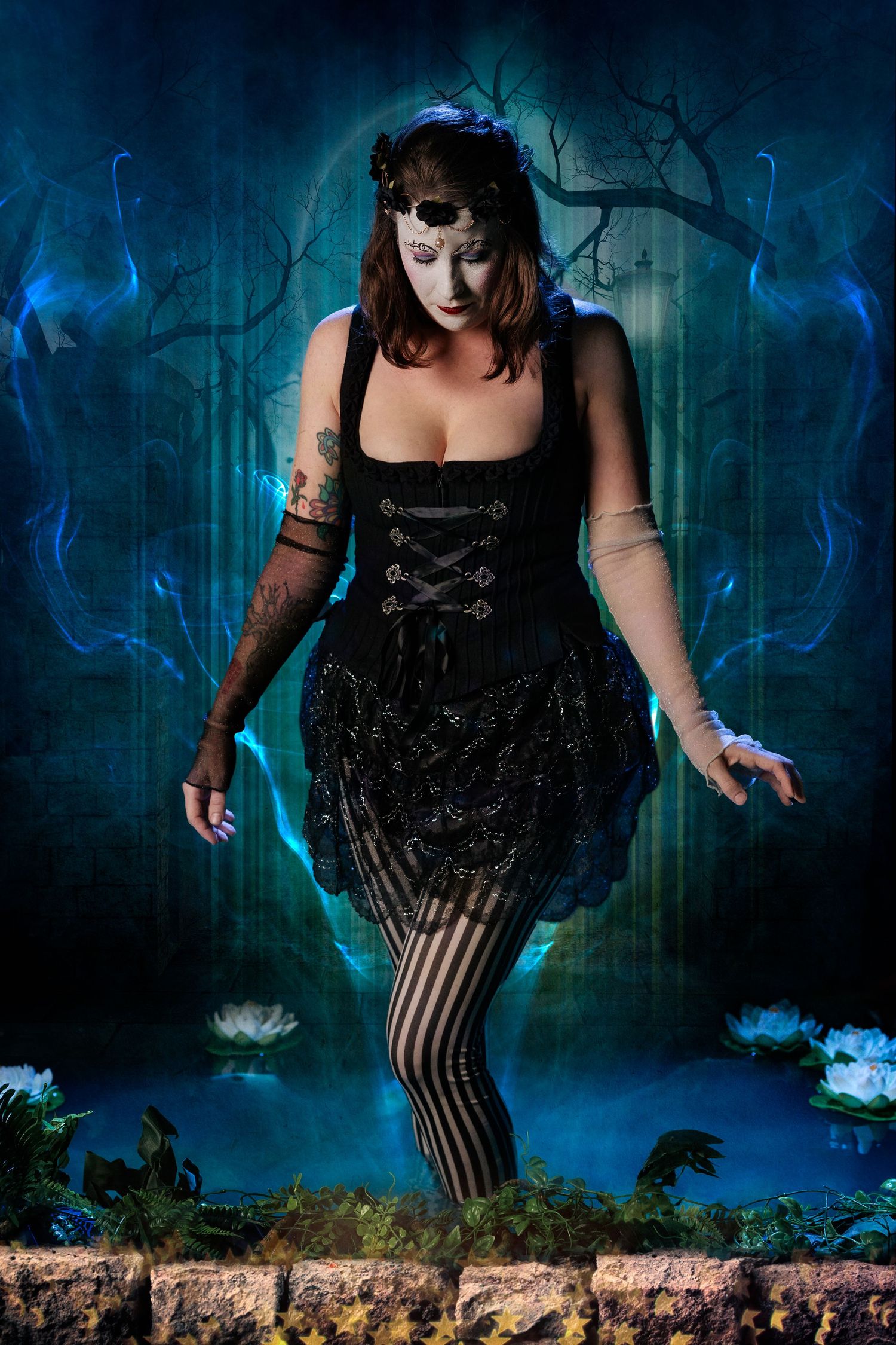 Gothic woman in black corset dress with face mask standing near enchanted blue forest pond at night.