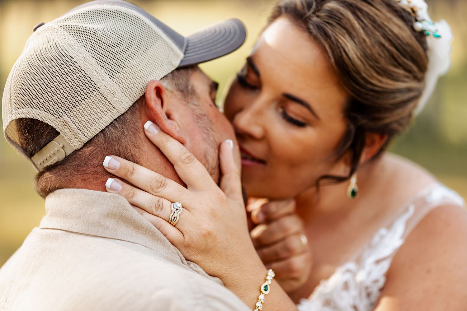 A tender moment between newlyweds, featuring an intimate embrace in soft natural lighting.