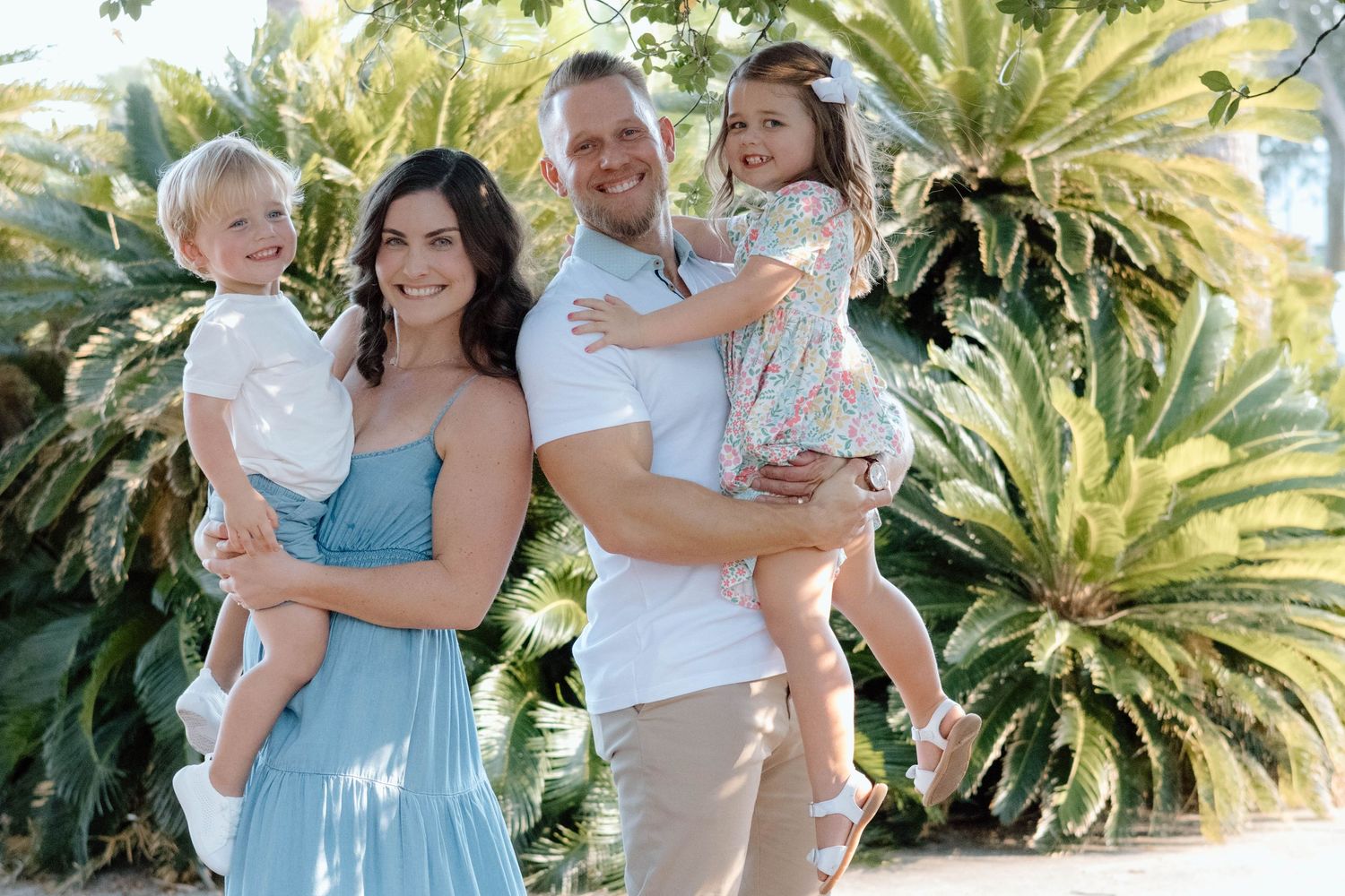 Parents playing with their toddler during a candid Tampa Bay family session.