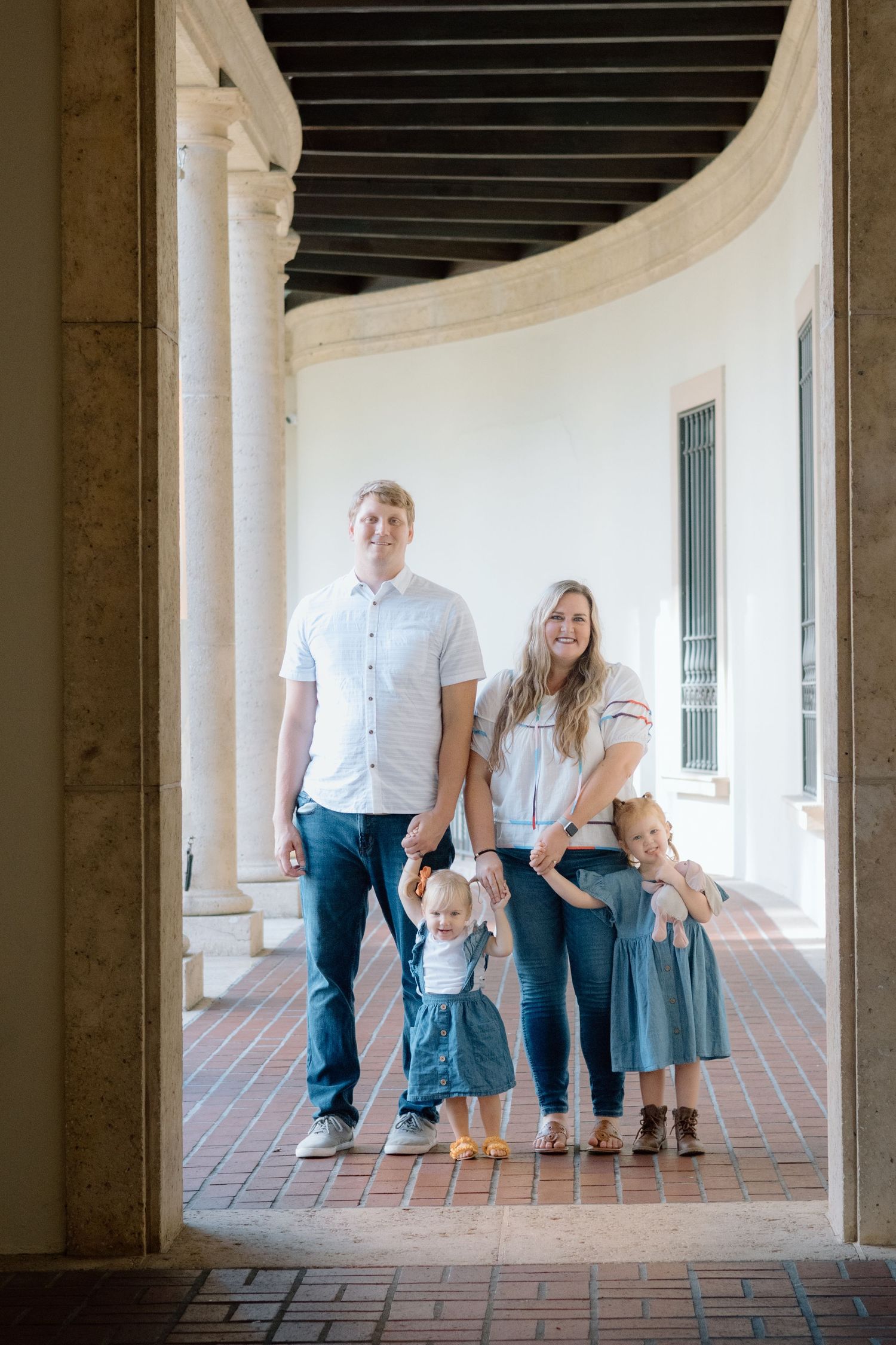Family walking together during a relaxed St. Petersburg family photography session. downtown st. petersburg photoshoot. museum of fine arts