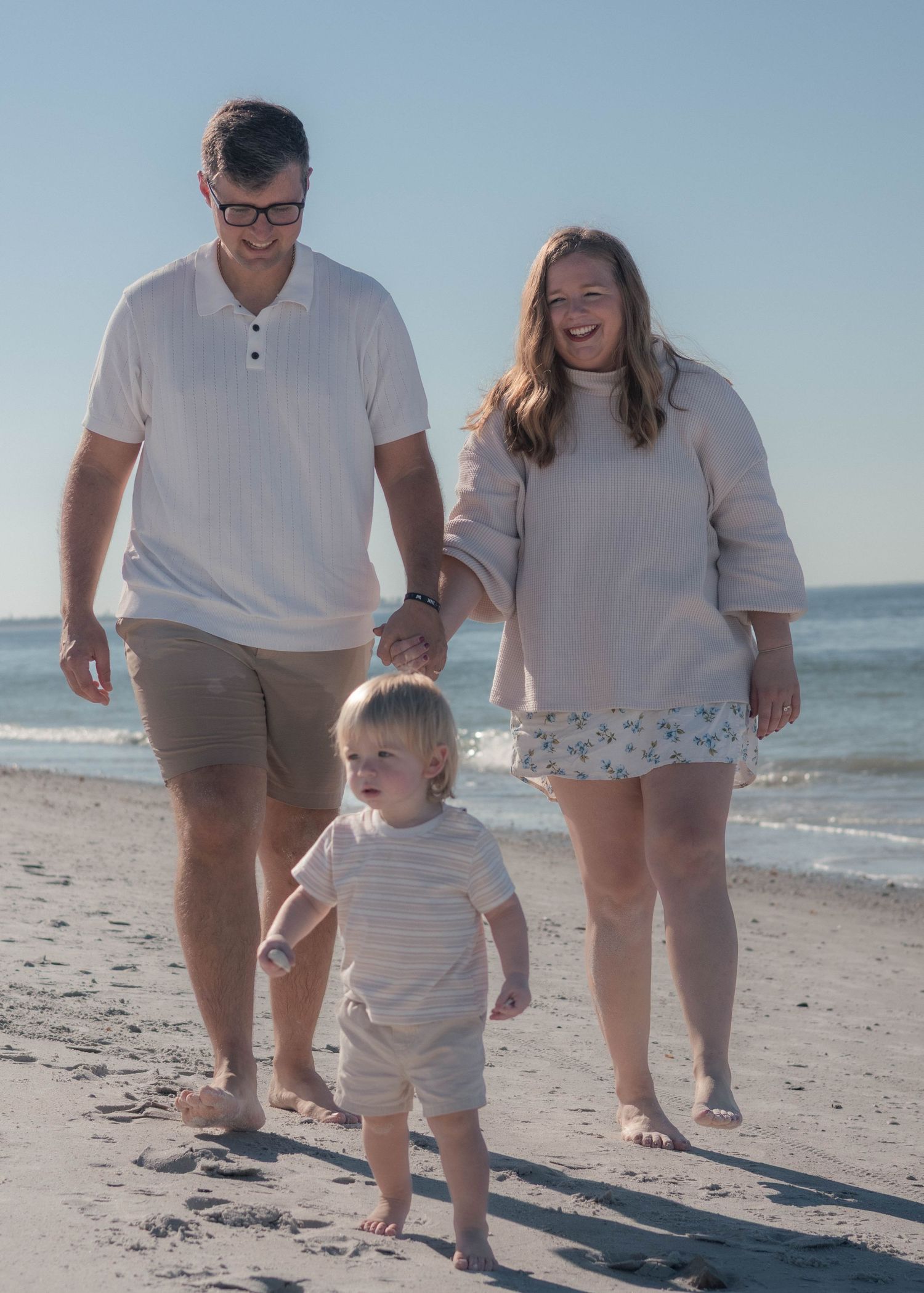 family strolling upham beach or st. pete beach for golden hour beach session