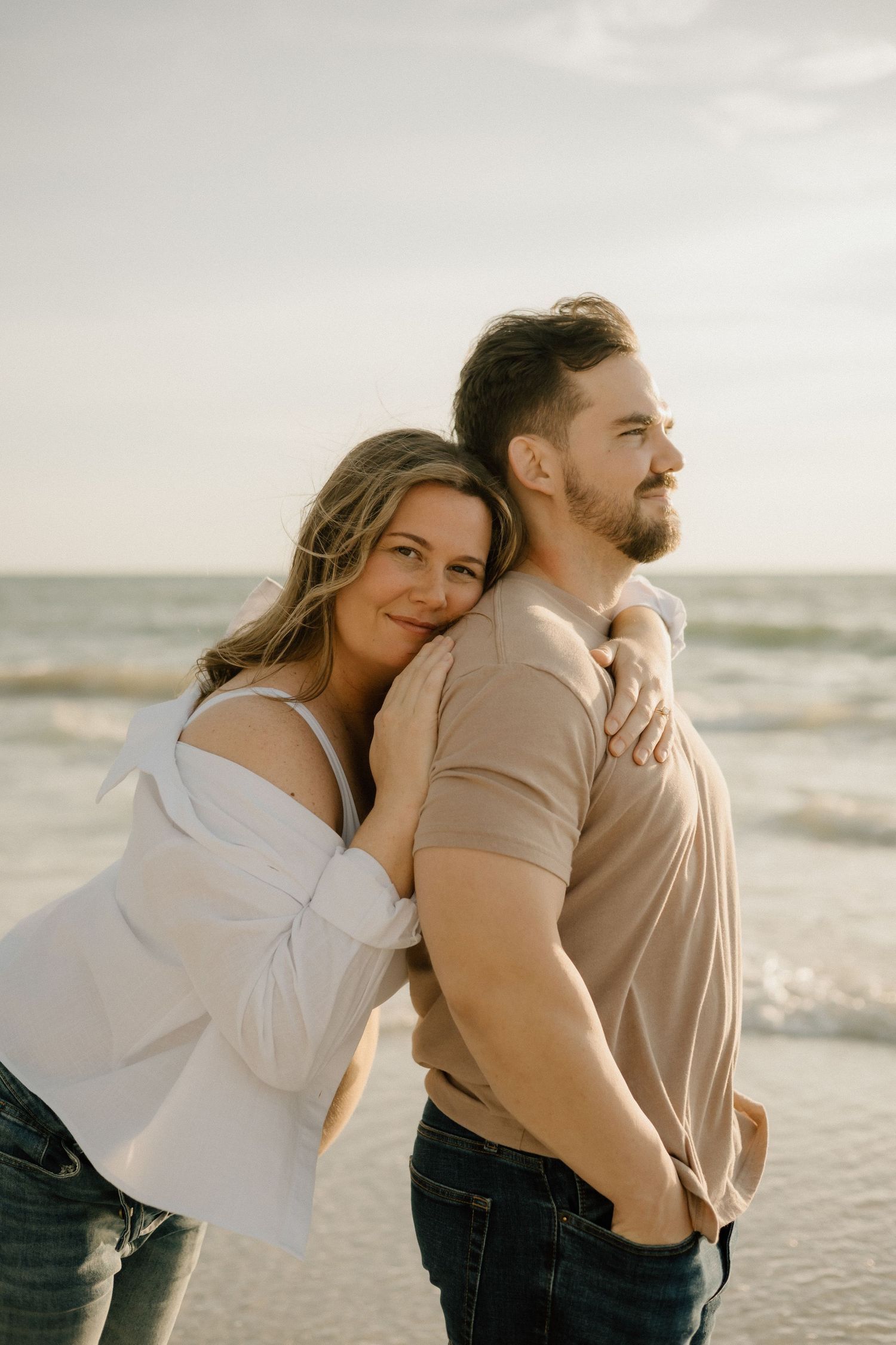 Couple embracing during an outdoor Tampa Bay maternity photography session.