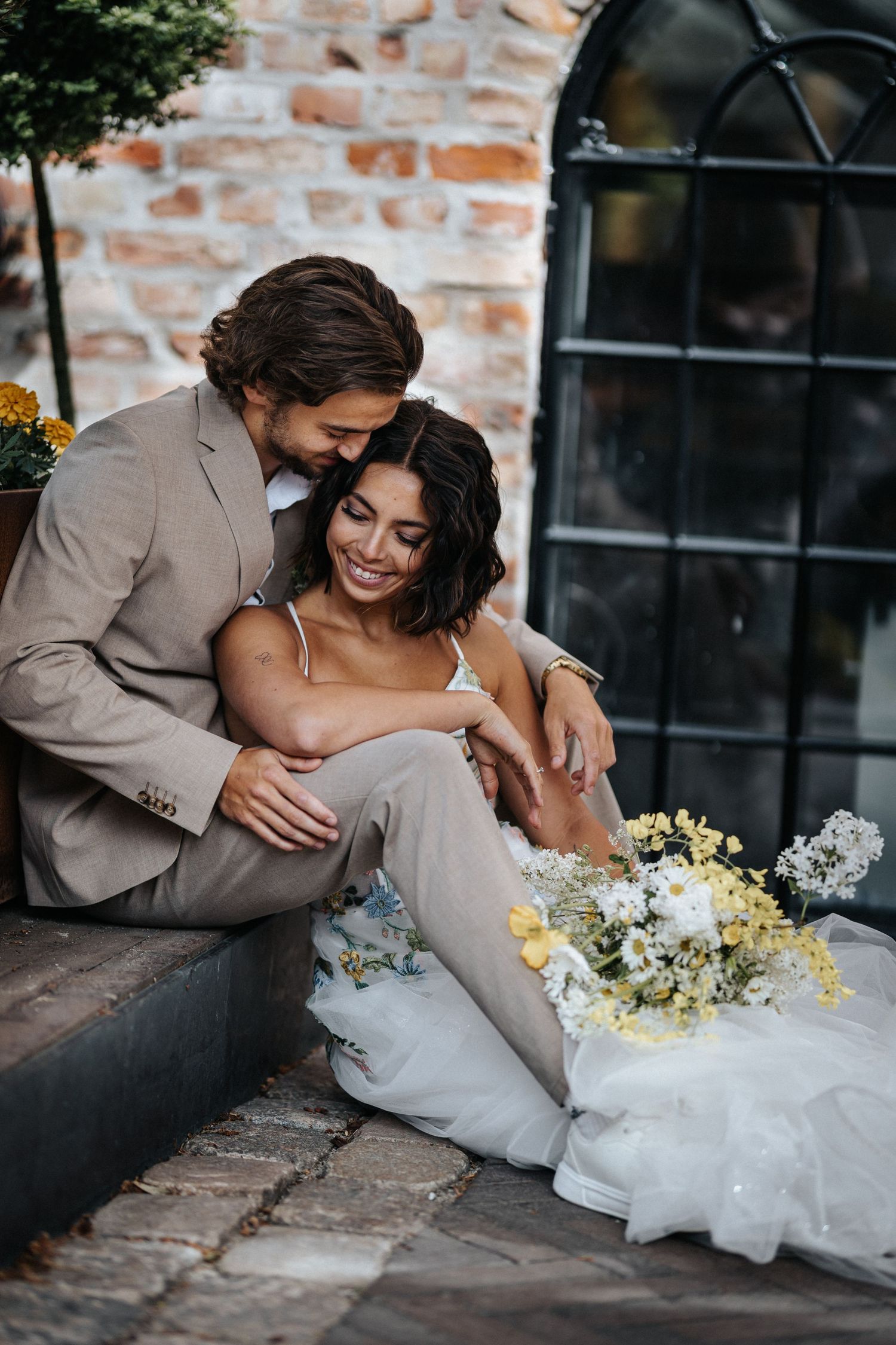 Romantic wedding photography sequence showing tender moments between newlyweds against a rustic brick wall backdrop.
