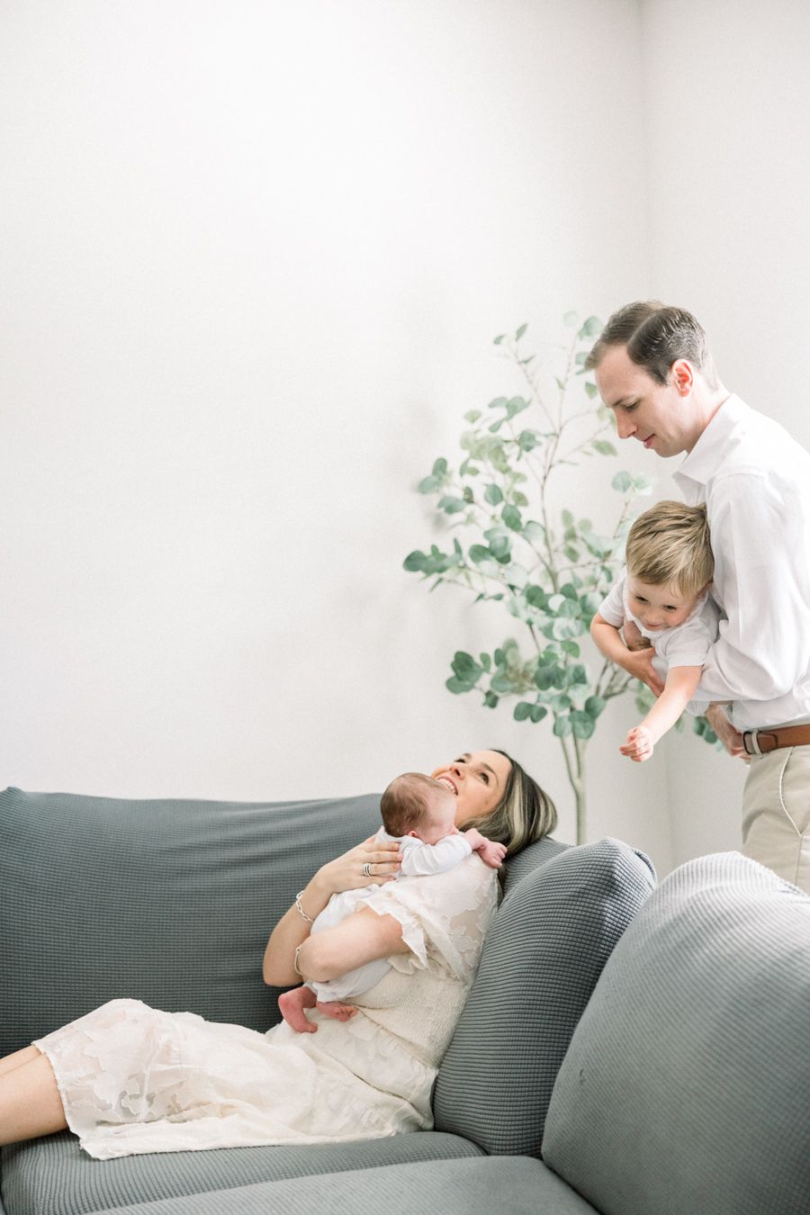 Family relaxing together during an Augusta in-home newborn photography session