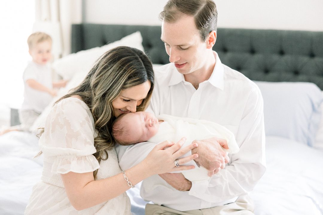 Family relaxing together during an Augusta in-home newborn photography session
