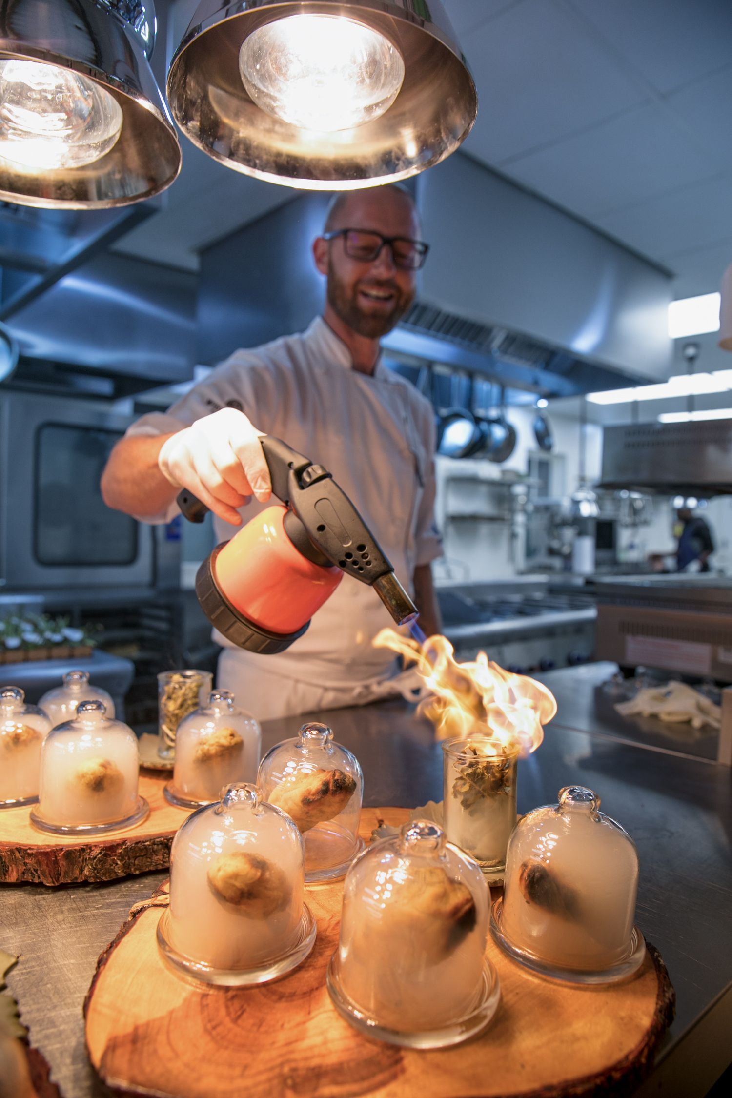 Chef preparing a meal at Forage restaurant at Wildekrans in the Western Cape.