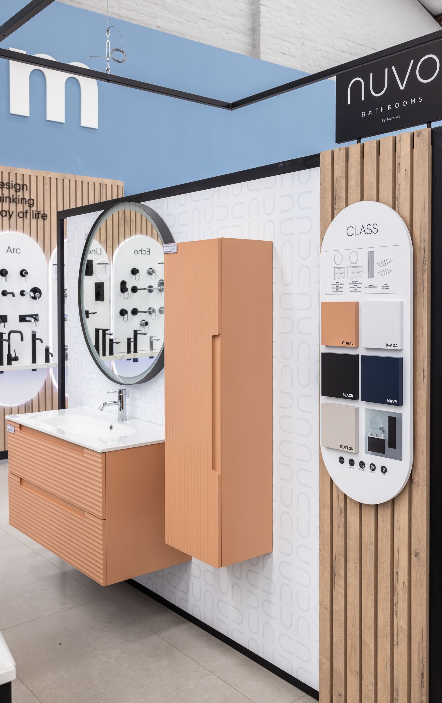 Contemporary bathroom product display wall with peach-colored panels and circular signage elements.