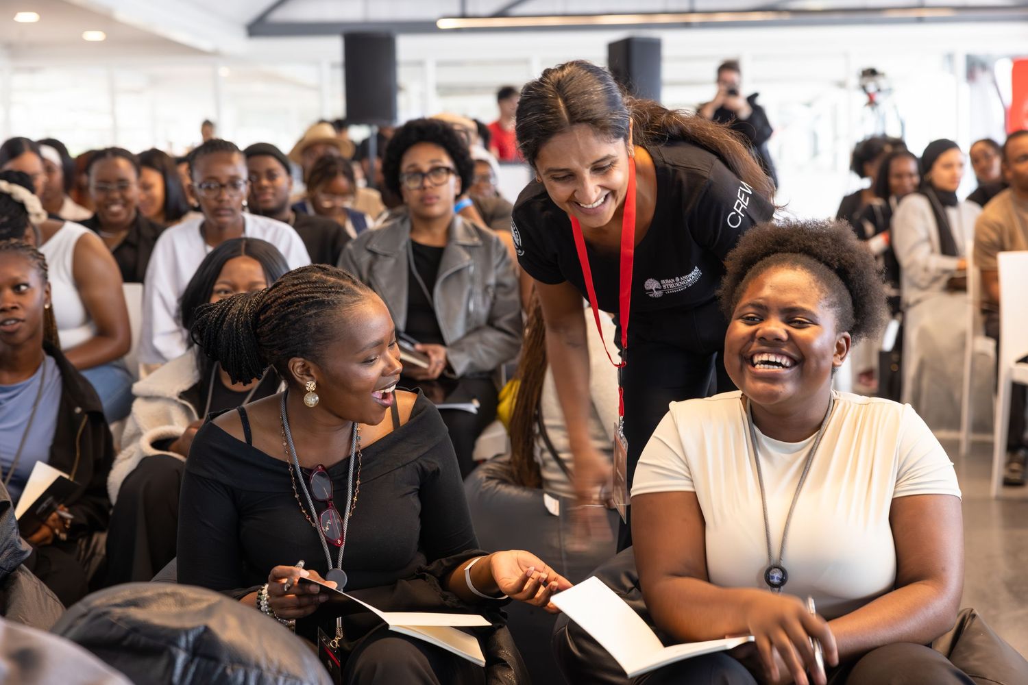 Large audience gathered for a professional development seminar in a conference room setting.