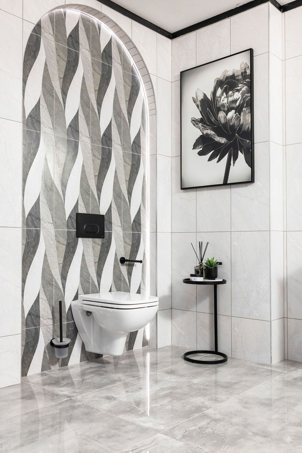 Modern bathroom interior with geometric patterned walls, round mirror, and black accents featuring a sleek minimalist design.