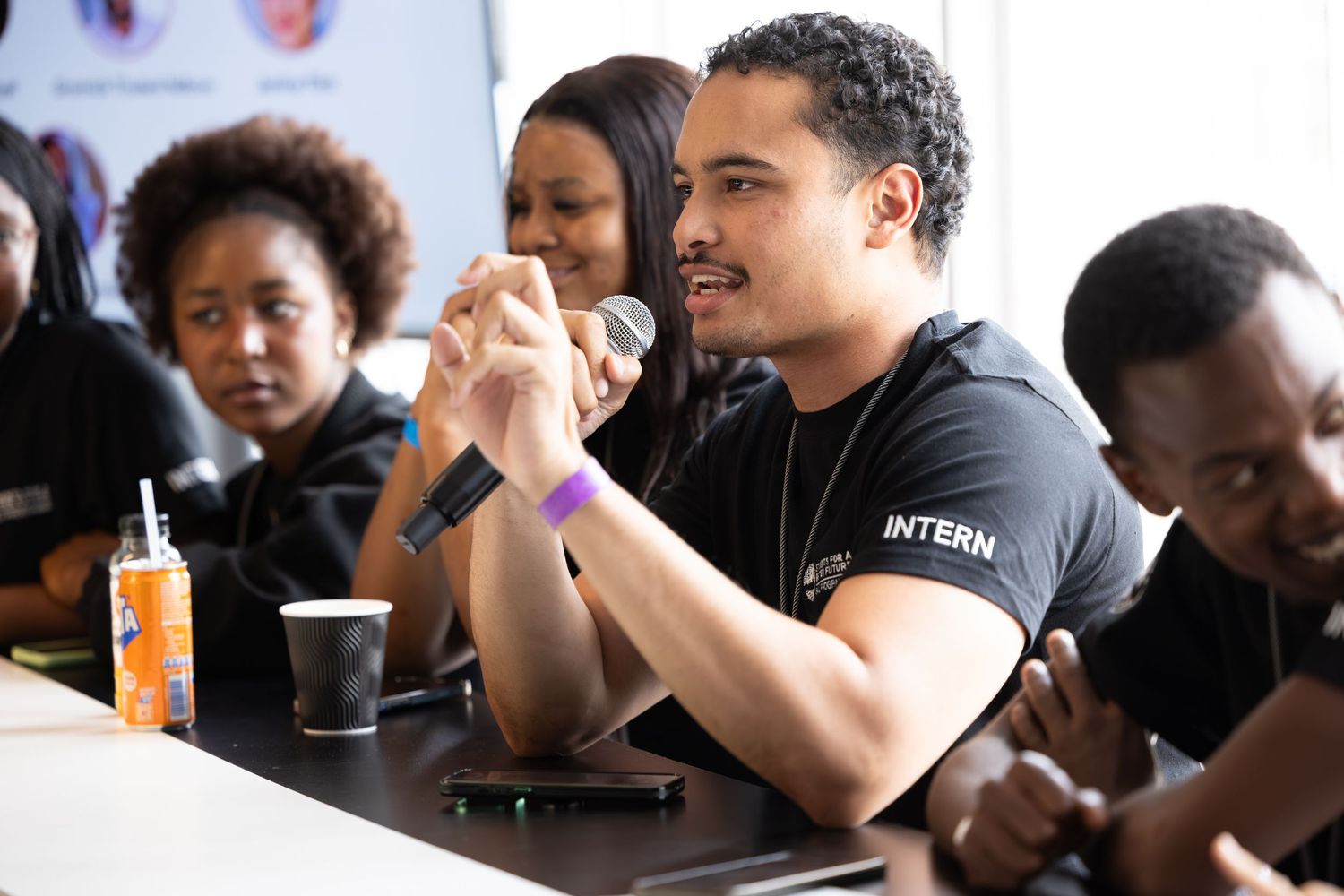 Attendees listening intently during an informal discussion session at a conference.