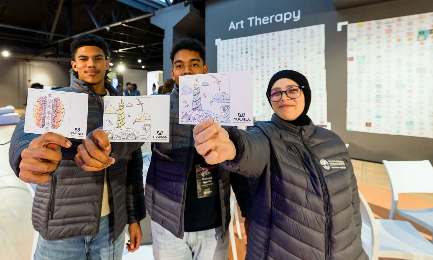 Participants display their artwork and notes during an art therapy workshop session.