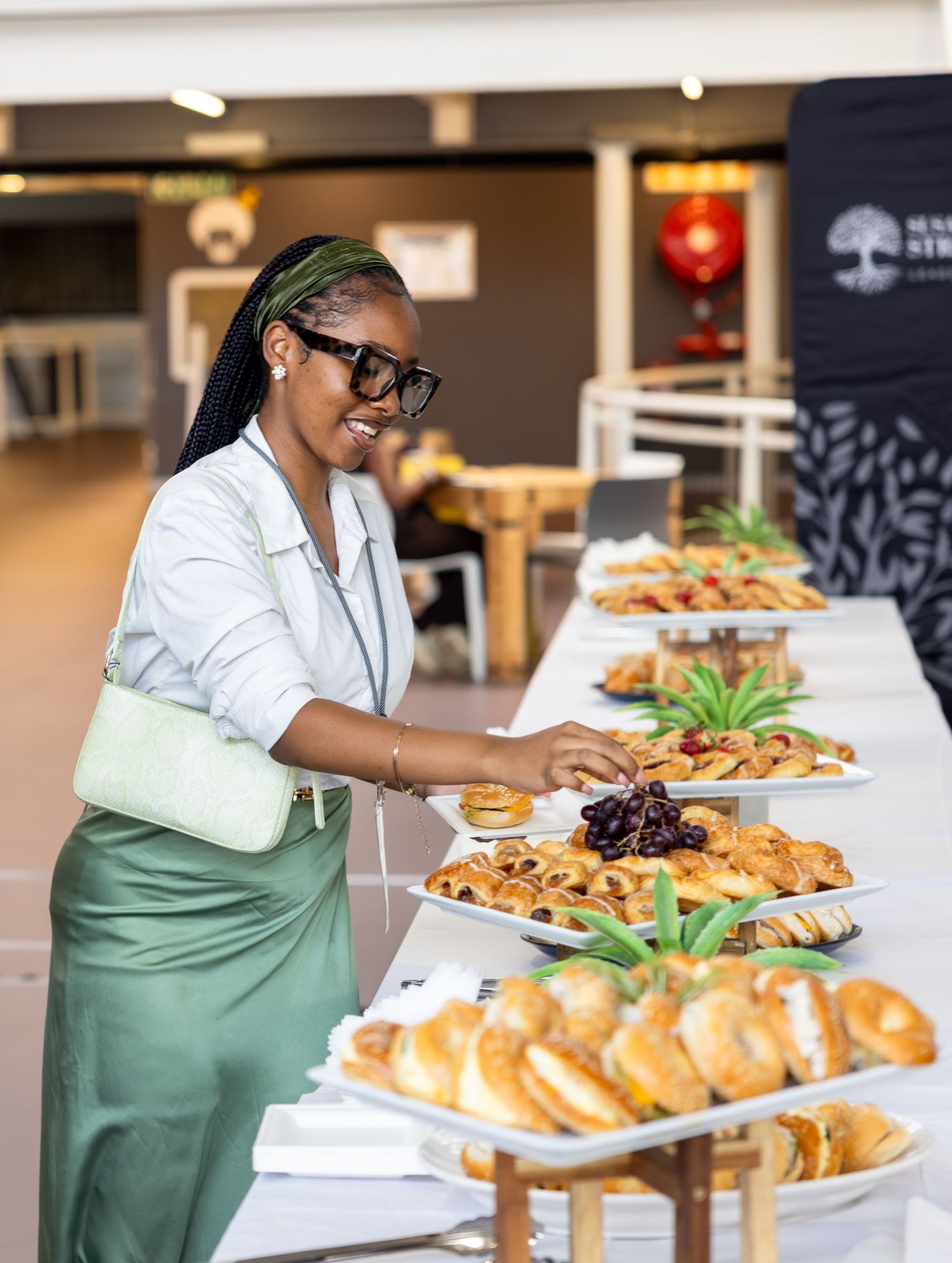 Fresh pastries and appetizers being arranged on serving platters at a catering event.