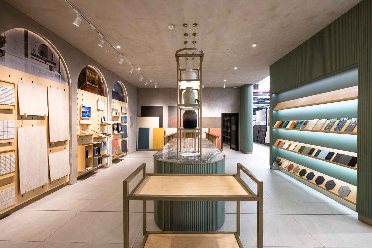 Contemporary office hallway featuring curved archways, display shelving, and mood lighting along a sleek corridor.